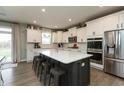 Bright kitchen featuring a large island, stainless steel appliances, and white cabinets at 8160 Shaldon Ct, Zionsville, IN 46077