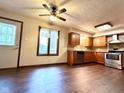Eat-in kitchen featuring stainless steel appliances, dark laminate floors, and a window offering natural light at 8616 Old Dominion Ct, Indianapolis, IN 46231