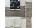 Selection of interior finishes including flooring, brick, paint, carpet, and cabinet samples at 9222 Anthem Ave, Plainfield, IN 46168