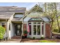Close up of charming brick and siding home with prominent front door and American flag at 9435 Tamarack Dr # 94, Indianapolis, IN 46260
