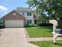 Charming two-story home with a brick-accented facade, well-maintained lawn, and driveway leading to an attached garage at 10629 Simsbury Ct, Indianapolis, IN 46236