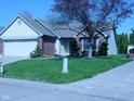 Well-kept lawn and landscaping enhance this charming one-story home at 10916 President Cir, Indianapolis, IN 46229