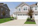 Beautiful townhome with a two-car garage, well-maintained lawn, and attractive landscaping at 1268 Newton St, Avon, IN 46123