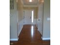 Inviting entryway featuring hardwood floors, decorative wainscoting, and a white front door with sidelight at 12866 Thames Dr, Fishers, IN 46037