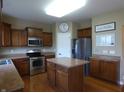 Charming kitchen boasts stainless appliances, a functional island, and plenty of cabinet space at 12866 Thames Dr, Fishers, IN 46037