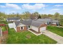 Aerial view of a well-maintained brick home, with mature trees and green lawn at 1463 Rebecca Ln, Franklin, IN 46131