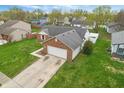 Birds eye view of a single-story brick home with a long driveway and a well-manicured lawn at 1463 Rebecca Ln, Franklin, IN 46131