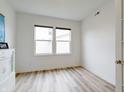Bedroom with neutral walls, wood floors, a closet, and natural light from large windows at 15702 Cobbs Crk Ln, Noblesville, IN 46060