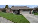 A single-Gathering home with a brick facade, well-kept lawn, and attached two-car garage at 16 Corkwood Ct, Brownsburg, IN 46112