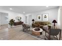 A bright living room with modern furniture, decor, and light wood flooring at 2200 W Christy Ln, Muncie, IN 47304