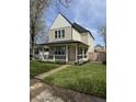Beautiful two-story home with a welcoming front porch and freshly landscaped yard at 2209 Carrollton Ave, Indianapolis, IN 46205