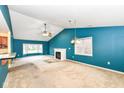 Bright living room showcasing a fireplace and open access to the kitchen area at 229 Waterford Ct, Avon, IN 46123