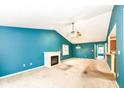Spacious living room featuring a fireplace, ceiling fan, and adjacent kitchen at 229 Waterford Ct, Avon, IN 46123
