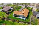 Aerial view of home, showing the backyard, a wooden deck, lush green lawn, and surrounding neighborhood at 2753 N High School Rd, Indianapolis, IN 46224