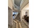 Bright foyer with a staircase, elegant railing, and views into the living and dining areas at 280 Walker Dr, Whiteland, IN 46184
