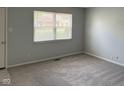 Clean and simple bedroom with neutral paint, new carpet and a nice street view through the blinds at 3333 Lupine Dr, Indianapolis, IN 46224