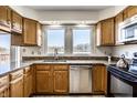 Well-lit kitchen boasts granite countertops, wood cabinets, and stainless steel appliances at 3634 W 58Th St, Indianapolis, IN 46228