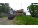 A quaint home with a rear deck and parking nestled by the roadside at 3818 Graceland Ave, Indianapolis, IN 46208