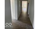 View of a long hallway with dark wood-look floors and white walls leading to several rooms at 3915 Donaldson Creek Ct, Clayton, IN 46118