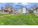 Inviting single-story home featuring a lush lawn and blue accents, creating a cozy curb appeal at 3924 E 30Th St, Indianapolis, IN 46218