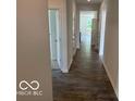 The bright hallway offers durable laminate flooring, white walls and doors, and natural light coming through the home at 3933 Donaldson Creek Ct, Clayton, IN 46118