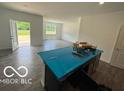 Spacious living area provides natural light, access to the backyard, and neutral paint color ready for customization at 3933 Donaldson Creek Ct, Clayton, IN 46118