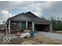 New construction home featuring a stone brick exterior, covered porch and attached two-car garage at 3949 Donaldson Creek Ct, Clayton, IN 46118
