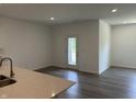 Bright living room featuring hardwood floors, white walls, recessed lighting, and a countertop at 3949 Donaldson Creek Ct, Clayton, IN 46118