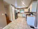This kitchen features stainless steel appliances, tiled floors, and white cabinets for a clean, classic design at 5329 Hawks Point Rd, Indianapolis, IN 46226
