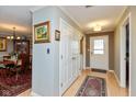 Bright entryway with neutral paint, wood floors, coat closet and views into the formal dining room at 5333 Thicket Hill Ln, Indianapolis, IN 46226