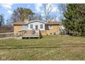 View of the back exterior showcasing a wooden deck and grassy lawn at 6436 E Hadley Rd, Mooresville, IN 46158