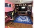 Cozy living room showcases a large entertainment center, dark leather couch, and an accent chair at 709 Braugham Rd, Indianapolis, IN 46227