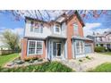 Charming two-story home with brick and vinyl siding and a well-manicured lawn in a lovely neighborhood at 716 Bristol Ct, Greenwood, IN 46143