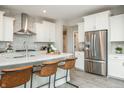Bright kitchen with stainless steel appliances, modern cabinetry, waterfall island, and stylish seating at 7282 Portico Ln, McCordsville, IN 46055