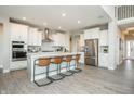 Spacious kitchen featuring a large island with seating, stainless steel appliances, and white cabinetry at 7282 Portico Ln, McCordsville, IN 46055