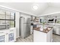 Bright kitchen featuring stainless steel appliances, a kitchen island, and modern finishes at 7715 High View Cir, Indianapolis, IN 46236