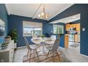 Cozy dining area featuring a modern table set, light fixture, and bright natural light at 8235 Picadilly Ln, Indianapolis, IN 46256