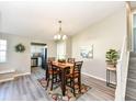 Inviting dining room with wood table, chandelier, and views into the kitchen at 8506 Friendship Ln, Indianapolis, IN 46217