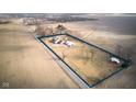 Aerial view of the property showcasing the home, outbuildings, and surrounding land at 8543 W County Road 600 S, Coatesville, IN 46121