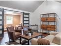 Comfortable living room with hardwood floors, modern shelving, and sliding doors leading to another room at 8737 Chateaugay Dr, Indianapolis, IN 46217