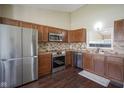 Modern kitchen featuring stainless steel appliances and beautiful wood cabinets at 10047 Perlita Pl, Fishers, IN 46038