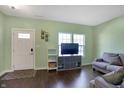 Cozy living room featuring wood floors, lots of natural light and a comfortable seating area at 10465 Long Branch Dr, Brownsburg, IN 46112