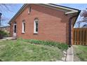Well-maintained brick house exterior featuring neat landscaping and fenced backyard at 1121 Canterbury Ct, Indianapolis, IN 46260