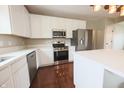 Modern kitchen featuring white cabinets, stainless steel appliances, and quartz countertops at 12332 Cobblefield Ct, Fishers, IN 46037