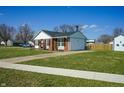 Charming brick home featuring a well-manicured lawn, driveway and side yard at 126 Windemere Rd, Whiteland, IN 46184
