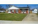 Charming brick home featuring a well-manicured lawn and driveway at 126 Windemere Rd, Whiteland, IN 46184