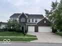 Traditional two-story home featuring a brick facade, attached two-car garage and well-manicured lawn at 1272 Southlake E Ave, Greenwood, IN 46143