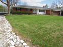 Well-maintained lawn and landscaped area in front of a single-story home with white and brick exterior at 13065 Allman Dr, Mooresville, IN 46158