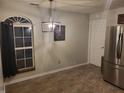 Bright dining area with stylish lighting, tile floor, and window overlooking the yard at 1317 Mulberry Ct, Greenfield, IN 46140