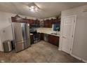 Spacious kitchen with stainless steel appliances and dark wood cabinets offers modern convenience at 1317 Mulberry Ct, Greenfield, IN 46140